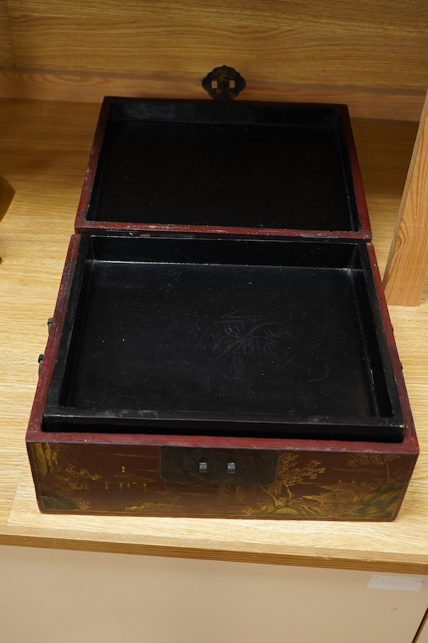 A Chinese lacquered box decorated with relief figures, 33cm wide
